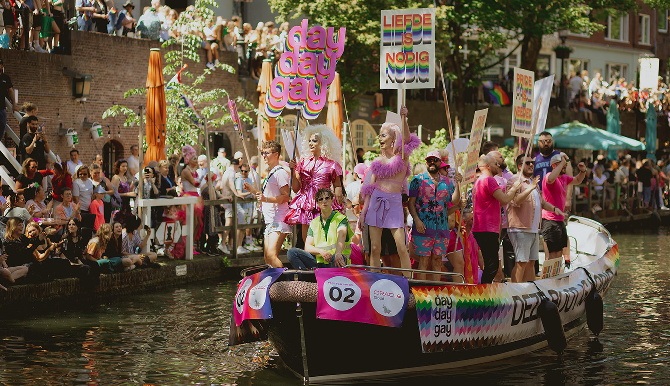 Utrecht Pride boat through canal with sign Love is needed Utrecht Pride boat through canal with sign Love is needed